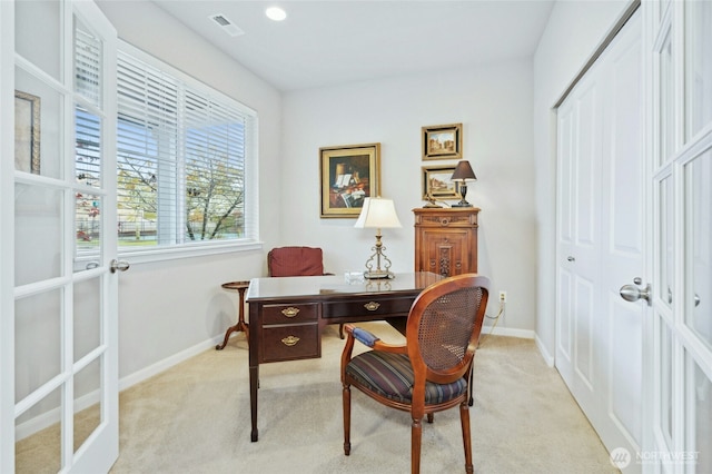 office featuring visible vents, baseboards, and light colored carpet