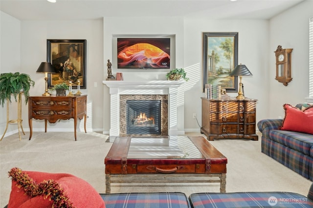 living room featuring carpet, a tile fireplace, and baseboards