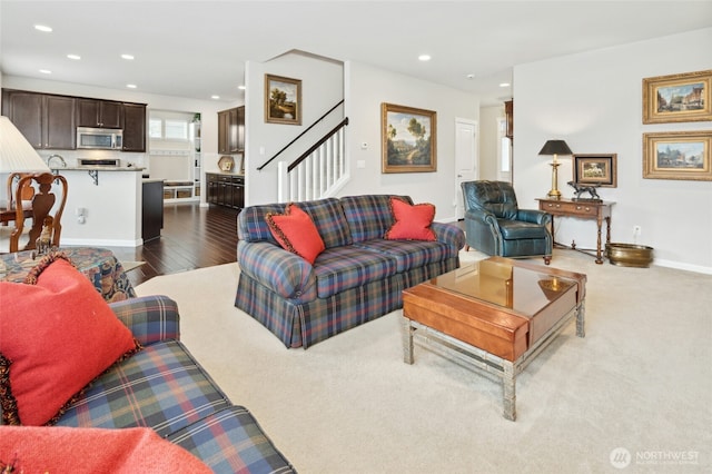 living room featuring baseboards, dark wood-type flooring, stairway, and recessed lighting