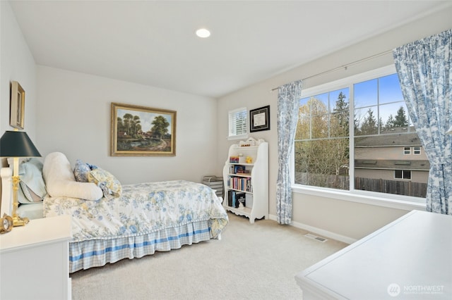 carpeted bedroom featuring visible vents and baseboards