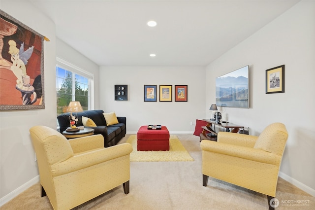 carpeted living area featuring baseboards and recessed lighting