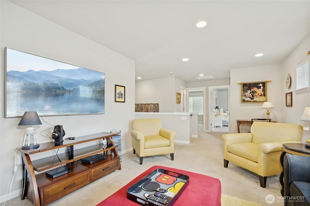 carpeted living area with recessed lighting and baseboards