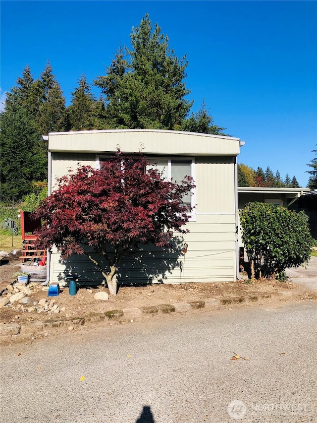 view of home's exterior featuring an outbuilding