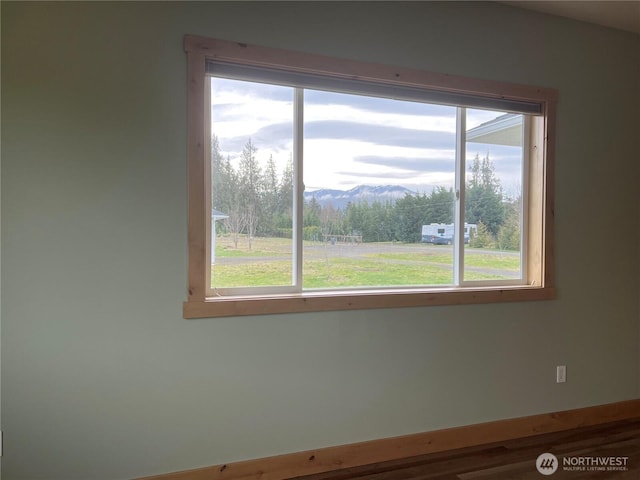 empty room with plenty of natural light and a mountain view