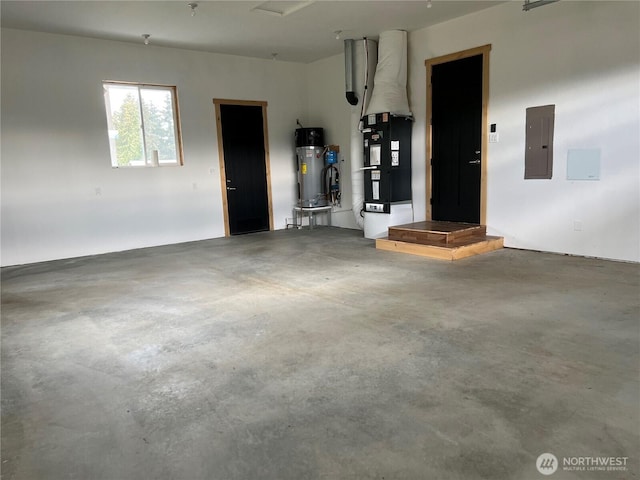 garage featuring electric panel, heating unit, and hybrid water heater