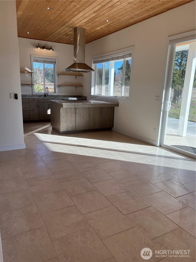 kitchen with light tile patterned floors, extractor fan, wooden ceiling, a sink, and baseboards