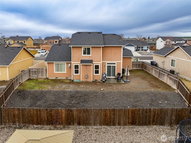 rear view of property with crawl space, a fenced backyard, a residential view, and roof with shingles