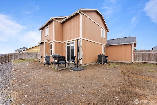 back of property with a patio, central AC unit, and a fenced backyard