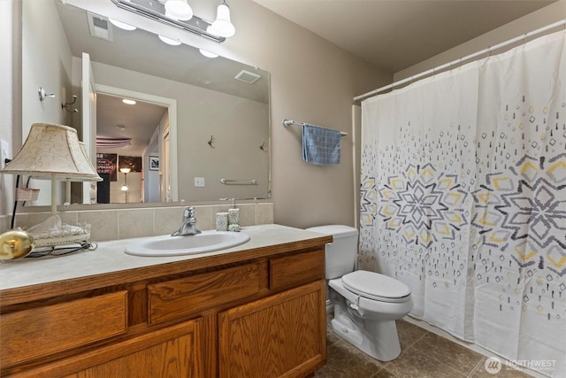 full bathroom with tile patterned flooring, visible vents, vanity, and toilet