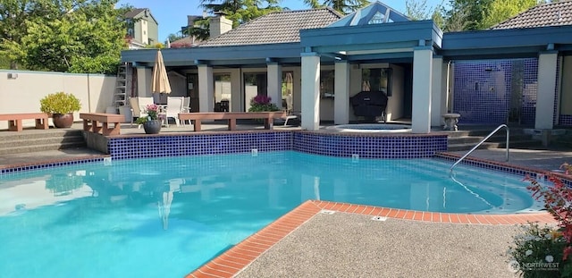 view of pool featuring a patio area, a grill, fence, and a fenced in pool