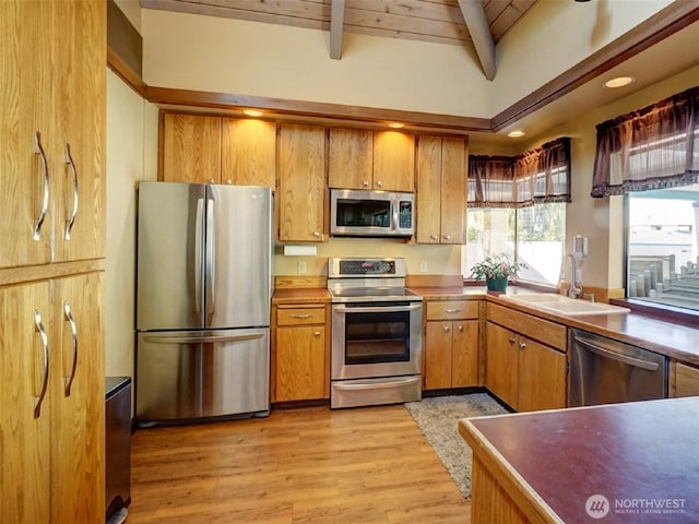 kitchen featuring wooden ceiling, appliances with stainless steel finishes, brown cabinets, light wood-type flooring, and a sink