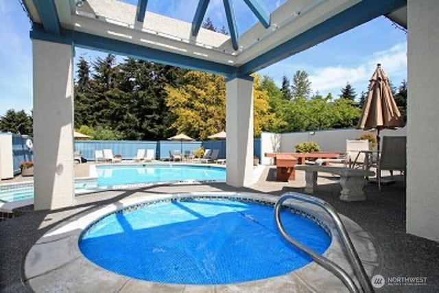 pool featuring a patio and fence