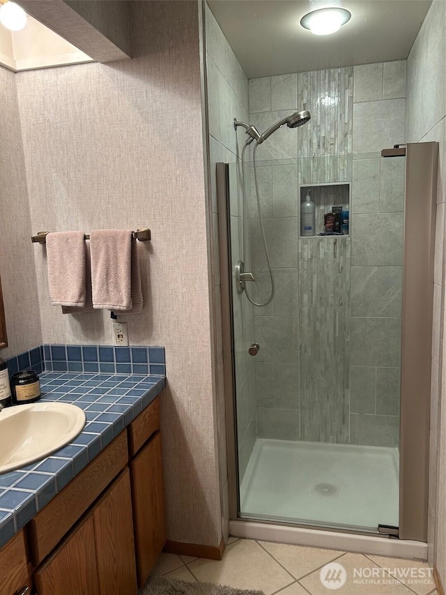 bathroom featuring a stall shower, vanity, and tile patterned floors