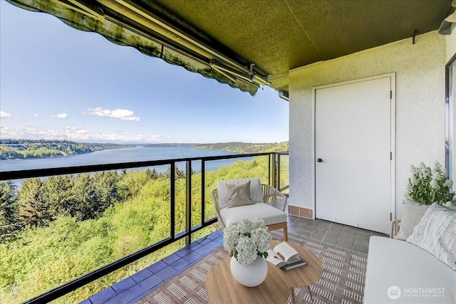 balcony featuring a water view