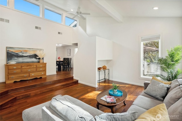 living area with a wealth of natural light, visible vents, and wood finished floors