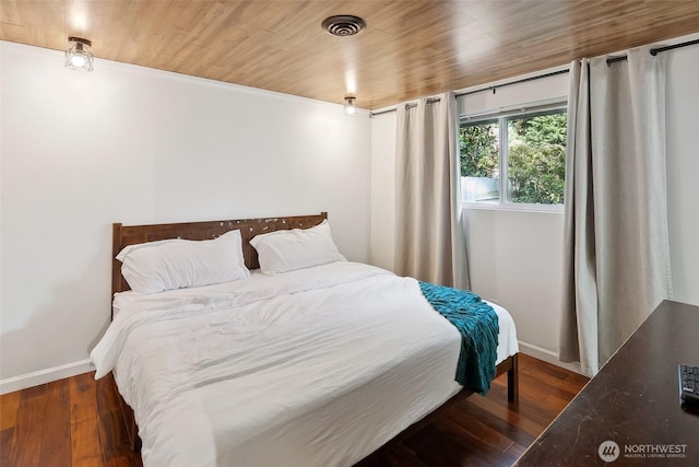 bedroom with wooden ceiling, wood-type flooring, visible vents, and baseboards