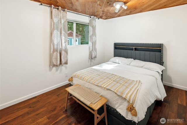 bedroom with wood ceiling, baseboards, and wood finished floors