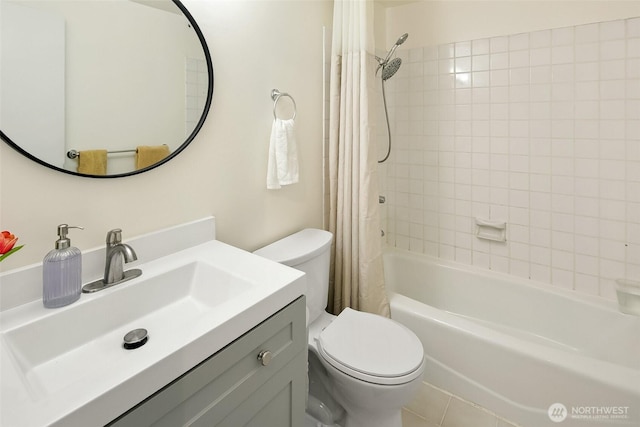 bathroom featuring vanity, toilet, and shower / bath combo with shower curtain