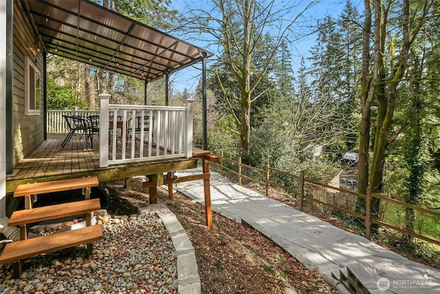 view of yard with outdoor dining area, fence, and a deck