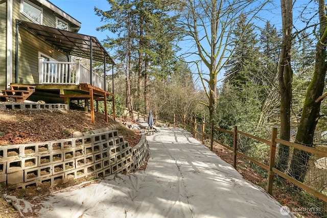 exterior space featuring fence and a wooden deck