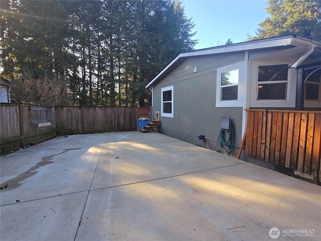 back of house featuring a patio area and fence