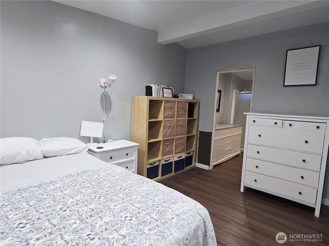 bedroom featuring ensuite bathroom, dark wood-type flooring, and beamed ceiling