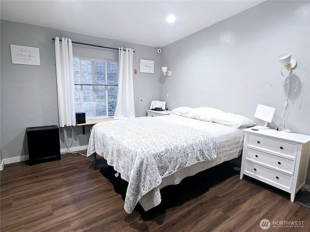 bedroom featuring dark wood-type flooring and baseboards