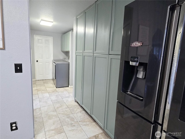 kitchen featuring washing machine and dryer, gray cabinets, light countertops, and refrigerator with ice dispenser