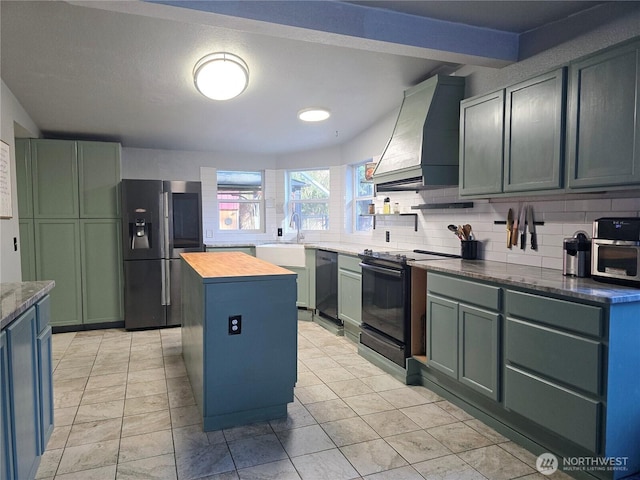 kitchen with custom range hood, backsplash, a kitchen island, a sink, and black appliances