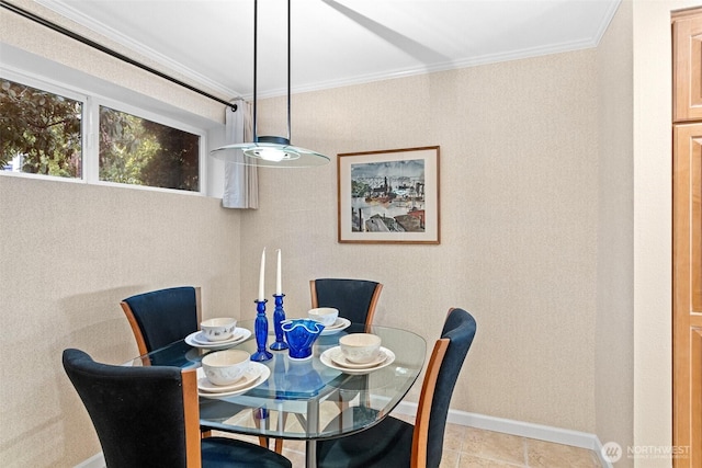 dining area with baseboards and crown molding