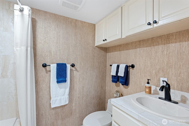 bathroom featuring toilet, a shower with curtain, visible vents, and vanity