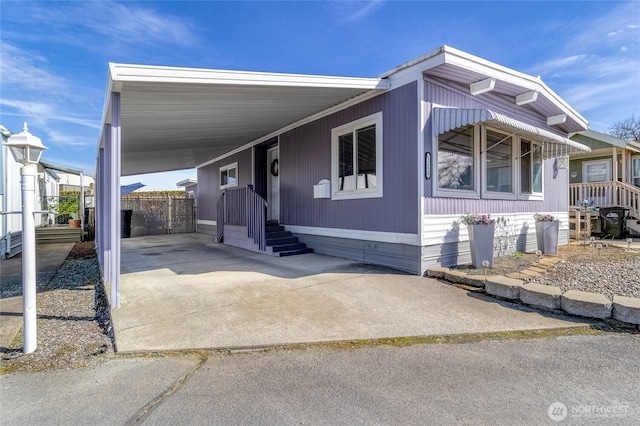 view of front facade featuring an attached carport and driveway