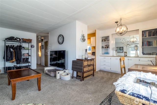 carpeted living area with a chandelier