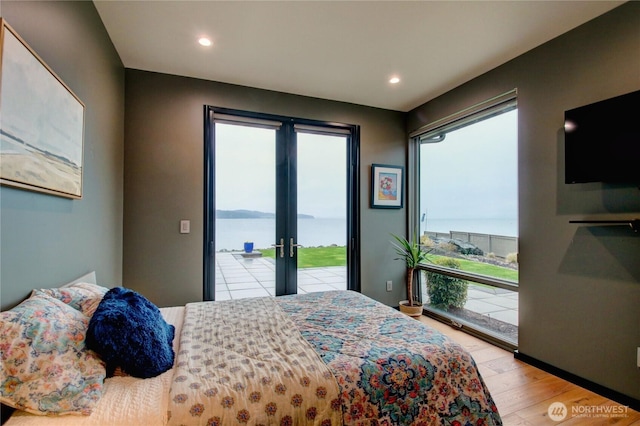 bedroom featuring french doors, wood finished floors, recessed lighting, and access to outside