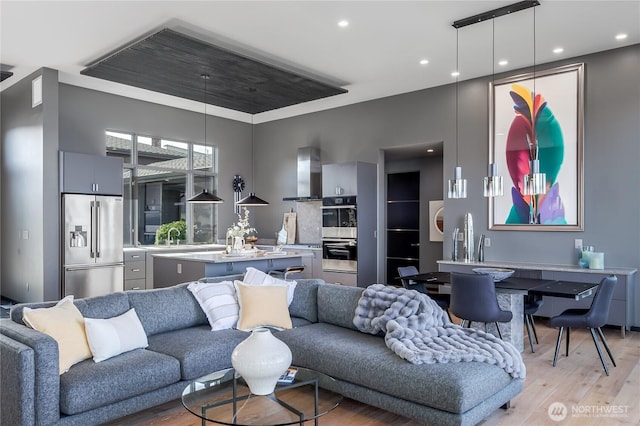 living area with recessed lighting and light wood finished floors