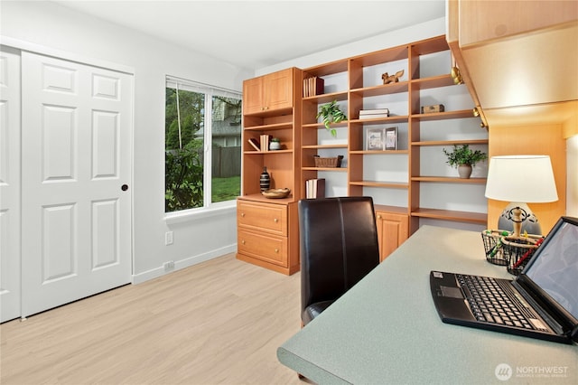 office with baseboards and light wood-style floors