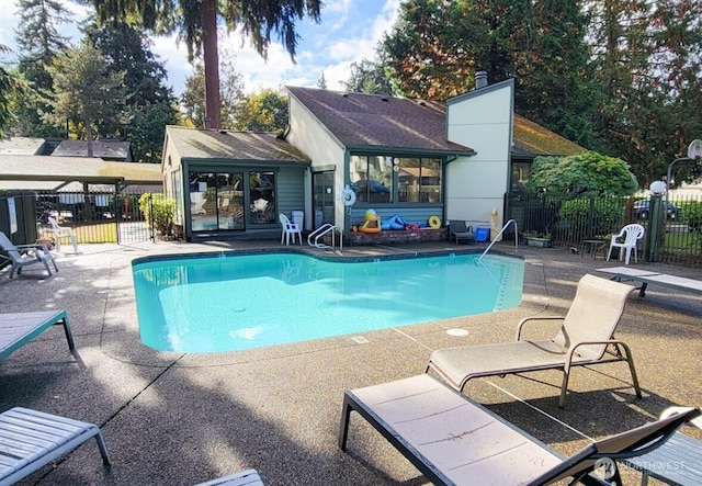 community pool featuring a patio area and fence