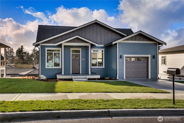 view of front of house with a shingled roof, board and batten siding, a front yard, a garage, and driveway