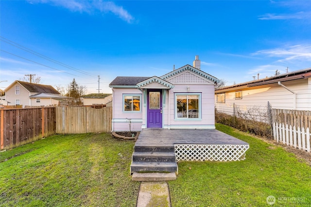 exterior space with a fenced backyard and a front yard