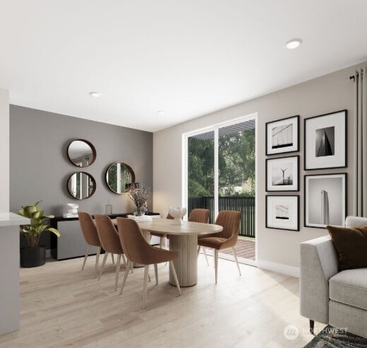 dining space featuring light wood-type flooring and baseboards