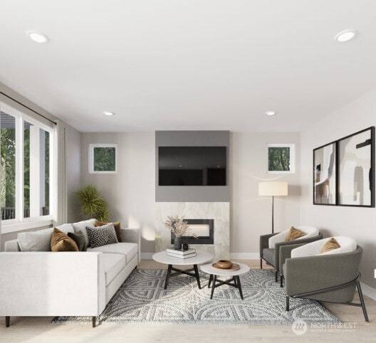 living area featuring a premium fireplace, recessed lighting, wood finished floors, and baseboards