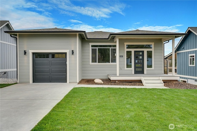 prairie-style home with an attached garage, driveway, and a front yard