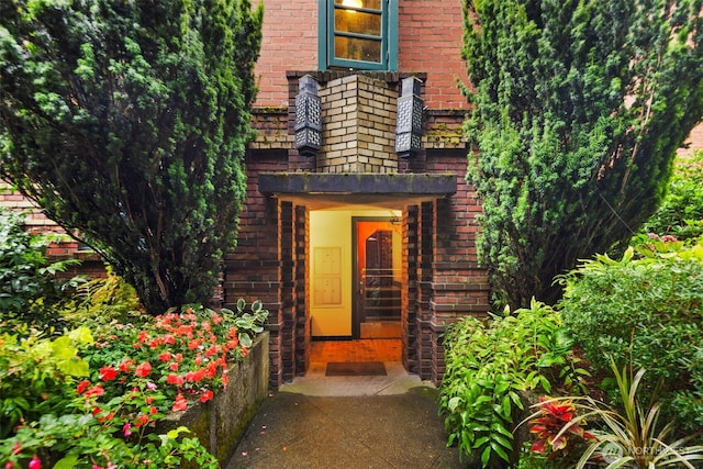 doorway to property with brick siding