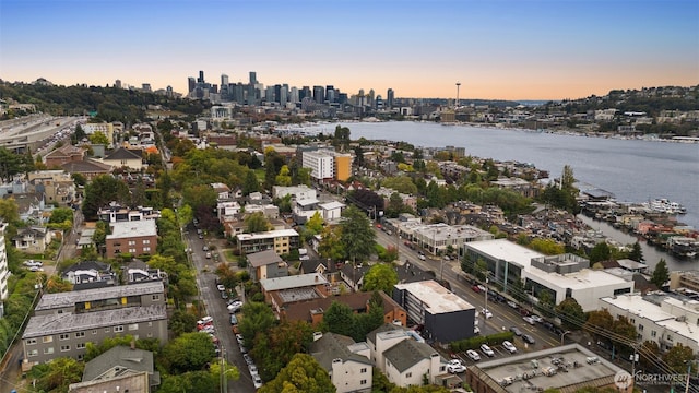 birds eye view of property featuring a water view and a city view