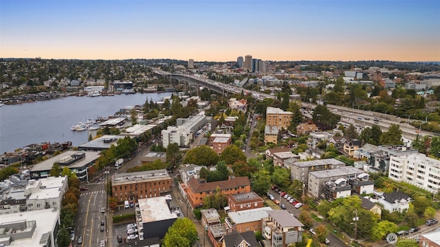 aerial view at dusk featuring a water view