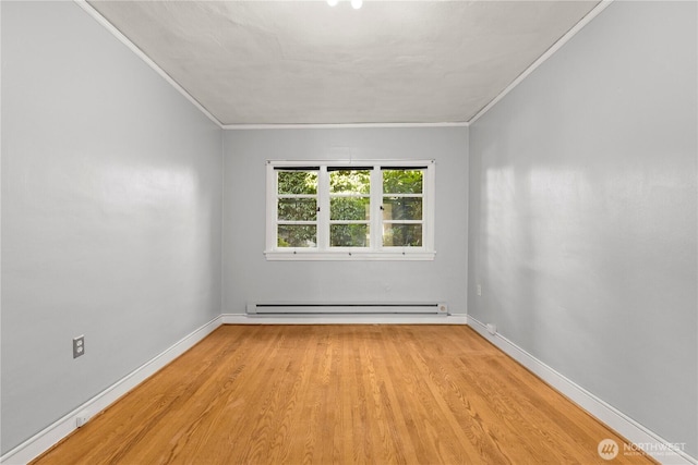 empty room featuring baseboards, baseboard heating, wood finished floors, and crown molding