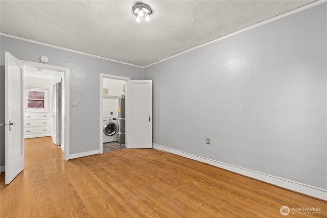 unfurnished bedroom featuring crown molding, light wood finished floors, washer / dryer, baseboards, and fridge