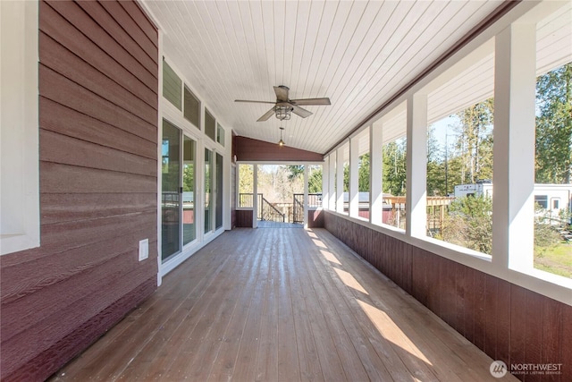 unfurnished sunroom with lofted ceiling, wooden ceiling, and plenty of natural light