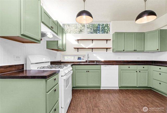 kitchen featuring white appliances, a sink, green cabinets, dark wood finished floors, and pendant lighting