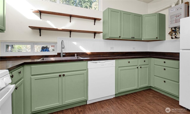 kitchen with white appliances, green cabinetry, a sink, and open shelves